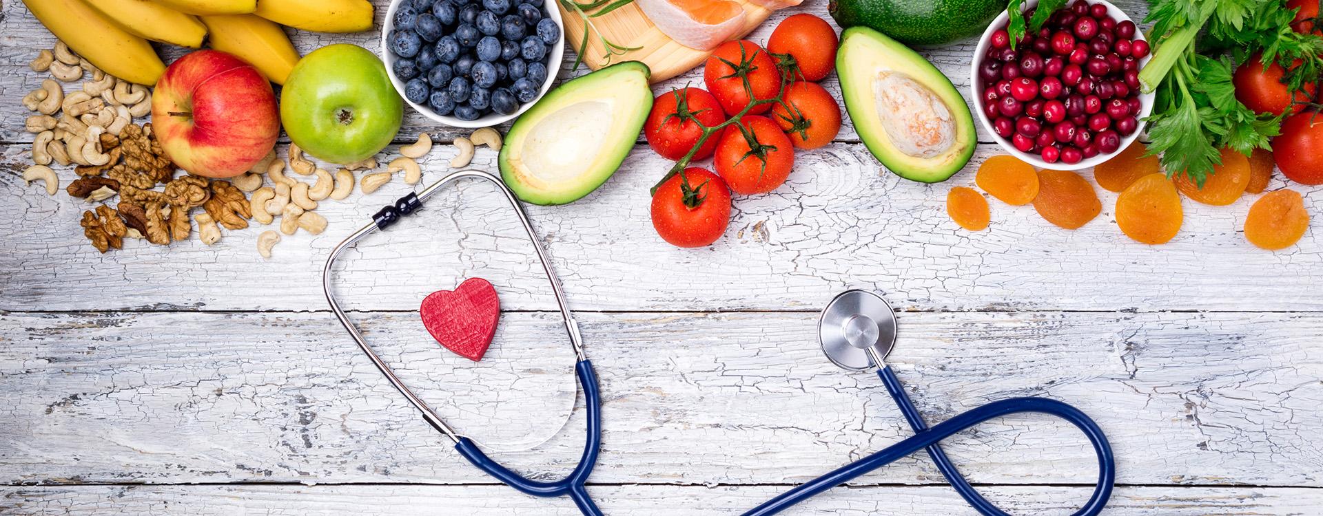 Stock image of healthy foods on table with stethoscope